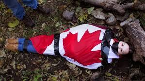 A photography student from Beausoleil First Nation in Ontario is hoping to bring awareness to missing and murdered Indigenous women and girls in Canada through her art. Charla Sylvester, 25 took the photo of a young woman on the ground looking up at the camera, her mouth covered and her body wrapped and taped up in a Canadian flag. Sylvester's cousin posed for the photo. Sylvester was thinking of Tina Fontaine, the 15-year-old from Sagkeeng First Nation whose body was found wrapped in a duvet when she was pulled from the Red River in Winnipeg in 2014. 