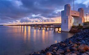 The Ted Smout Memorial Bridge is the second longest bridge in Australia, measuring about 2.7 kilometers long. Ted Smout was Australia's oldest surviving World War I veteran when he died on 22 June 2004 at the age of 106. The bridge has three spans, two for regular traffic and one for transit. It also has a pedestrian and cycle path that's 4.5 meters wide on both sides. The bridge is 3.8 meters high and can withstand strong winds and storms. Would you ride a bike across this bridge if you had the opportunity to?