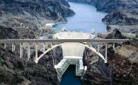 Hoover Dam spans the Colorado River in Black Canyon between Arizona and Nevada, some 30 miles southeast of Las Vegas Nevada. Constructed in the 1930s, the concrete arch-gravity structure was intended to prevent flooding as well as provide much-needed irrigation and hydroelectric power to arid regions of states like California and Arizona.. At 726 feet high and 1,244 feet long, Hoover Dam was one of the largest man-made structures in the world at the time of its construction, and one of the world's largest producers of hydroelectric power. Have you heard of this dam?