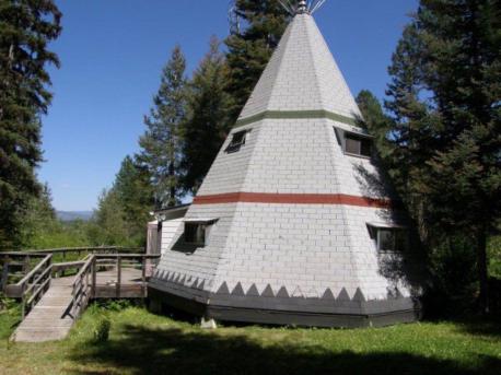 Idaho: Teepee House - This teepee house, built in Cascade, Idaho, is a tiny home consisting of a quaint 826 square feet. Inside are two bedrooms, a half bath, a kitchen, and a wood stove (there's a bathhouse just outside). Located in the middle of the woods, this home is all about accessing the simple things in life—like the wooden deck made for stargazing. Have you ever sat in a teepee?