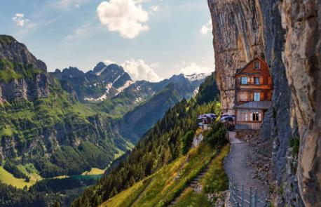 Berggasthaus Aescher, Schwende, Switzerland - It's a long and arduous hike or a meandering cable car journey (followed by a shorter hike) up to this 19th-century inn, which clings vertiginously to the side of the Ebenalp mountain in the Appenzell region of the Swiss Alps. Berggasthaus Aescher was built by farmers as a place to rest while their goats grazed. Now it's a jaw-dropping destination restaurant and guesthouse with views across the valleys to Lake Constance. The food is typical hearty Alpine fare with lots of cheese, eggs and potatoes – much needed for the return journey. Have you ever been to this restaurant?