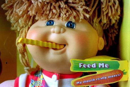 Cabbage Patch Snacktime Kid - In 1996, the popular Cabbage Patch Kids toy line released the Snacktime Kid, with a motorized mouth to munch on the plastic food that came in the box. The problem was the doll didn't know what was food, what wasn't, or when to stop, and there were numerous reports of the dolls eating poor kids' hair up to their scalps and even injuring fingers. Are you familiar with this toy?