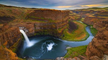 Washington: Palouse Falls - Dropping over 200 feet, Palouse Falls sits surrounded by a set of striking cliffs, which makes its descent all the more dramatic. After the Palouse River takes its trip over the rim of the falls, it carries on its journey down a twisty canyon, only adding to the natural beauty of the scene. Have you ever been to this waterfall?